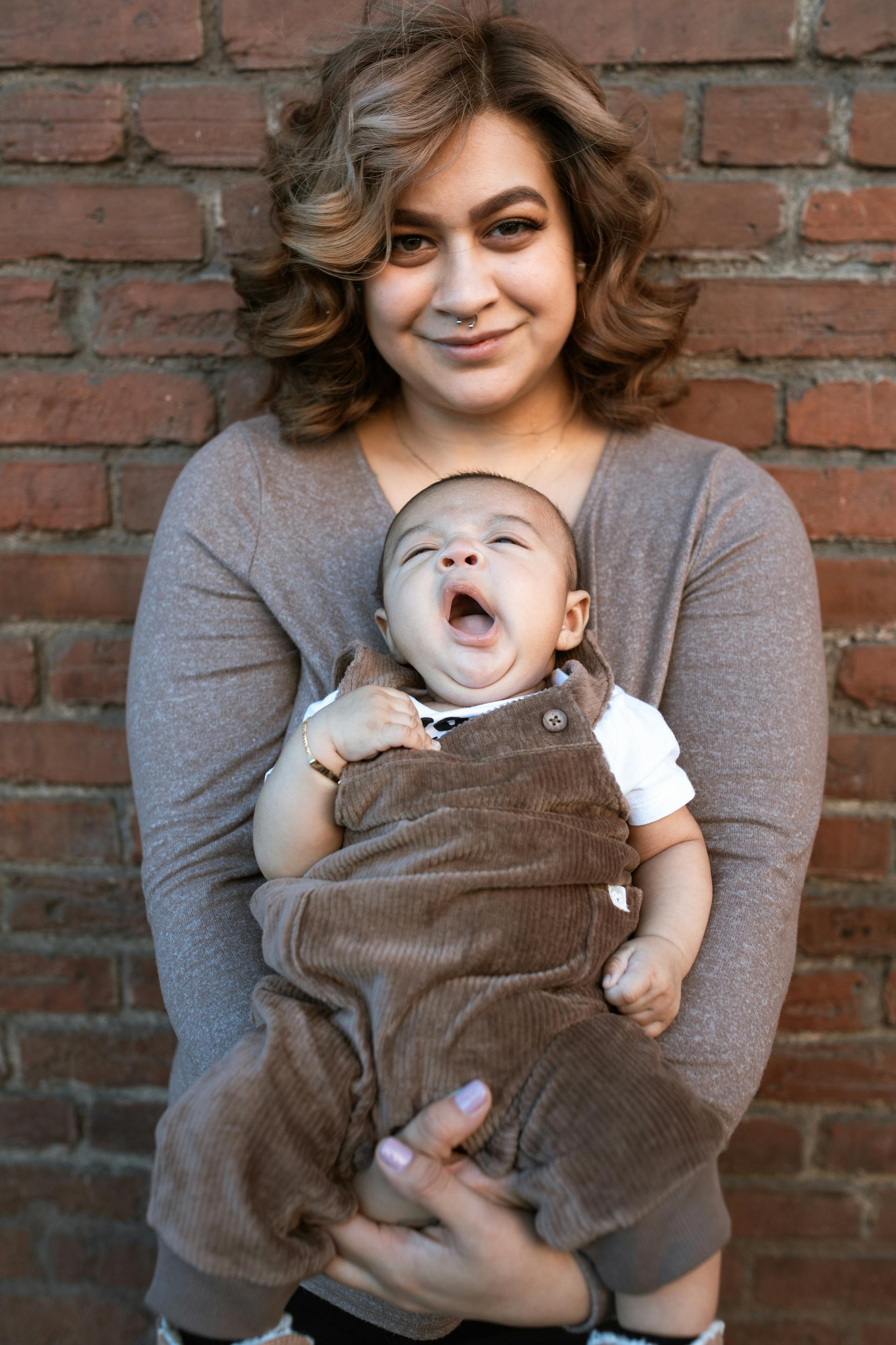 Hispanic mother holding her baby with joy